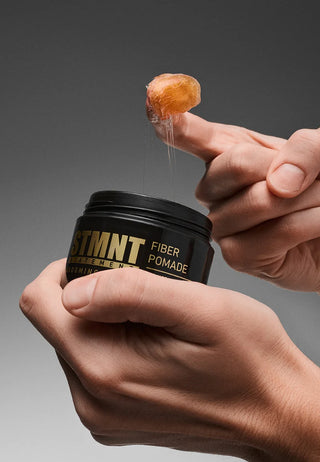 STMNT Fiber Pomade fiber texture on fingertip